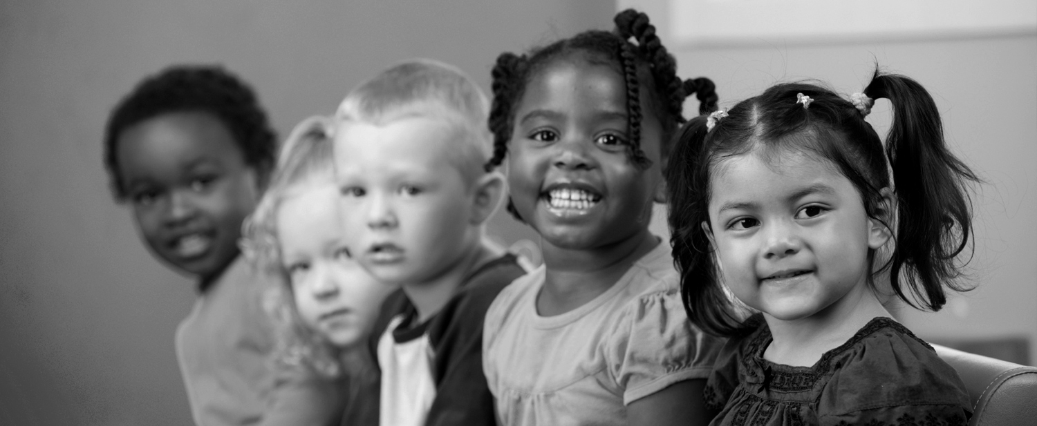 Diverse group of young children sitting together — symbolizing unity and community